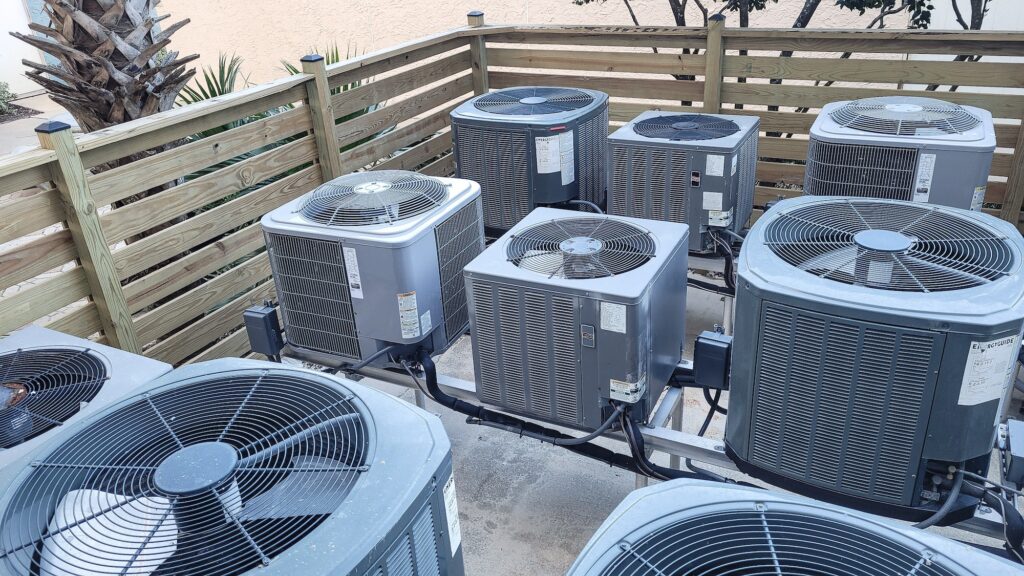 Air conditioners raised platforms at beach serviced by HVAC technicians .